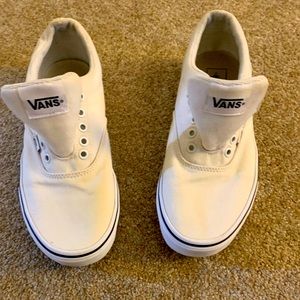 All white Vans with navy blue trim.